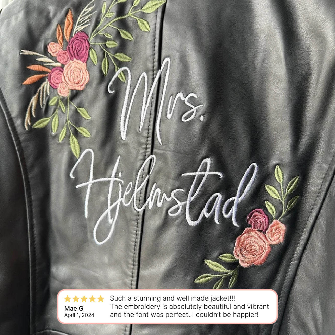 a leather jacket with embroidered flowers on it