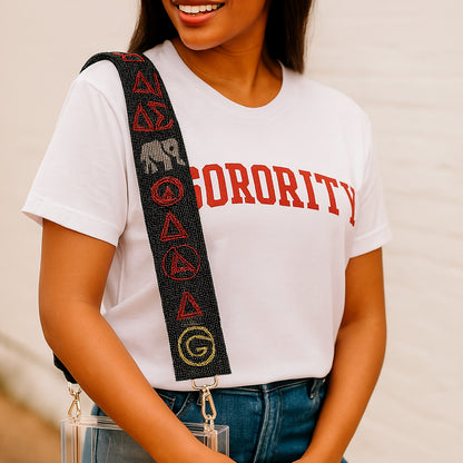 a woman wearing a white shirt and a black and red belt