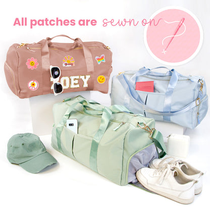 a variety of colorful bags and accessories, including a pink duffel bag, a blue duffel bag, and a green duffel bag, along with a pair of sunglasses, a hat, and a pair of white sneakers.