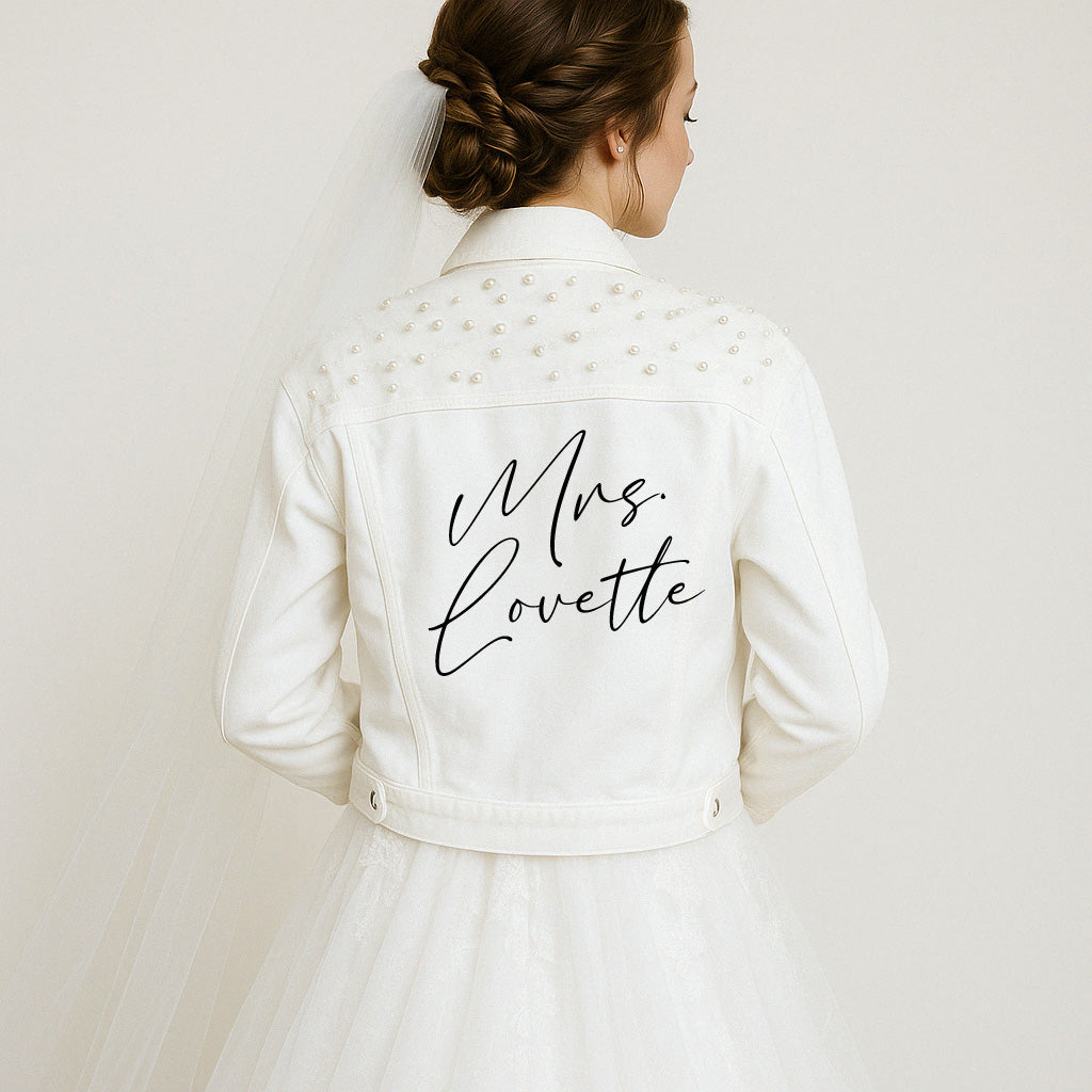 a woman in a wedding dress with a jacket on her back