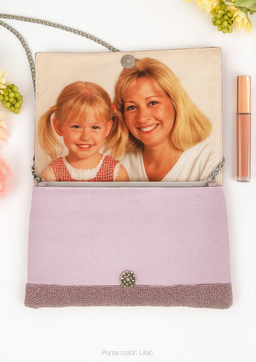 A purse with a photo of a young girl and an adult woman printed on it, along with some flowers and a lip gloss tube.