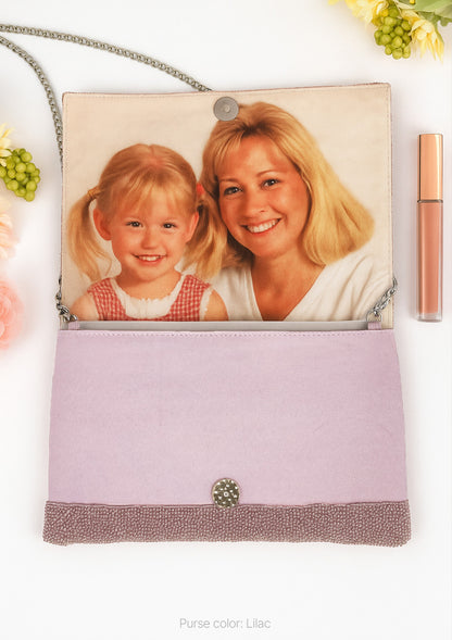 A purse with a photo of a young girl and an adult woman printed on it, along with some flowers and a lip gloss tube.