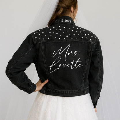 a woman in a wedding dress wearing a black jacket