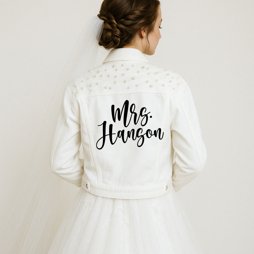 a woman in a wedding dress wearing a white jacket