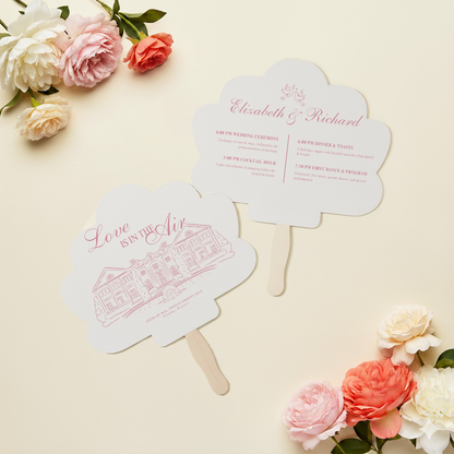 two fan-shaped cards with text and illustrations, placed on a light-colored background with flowers.