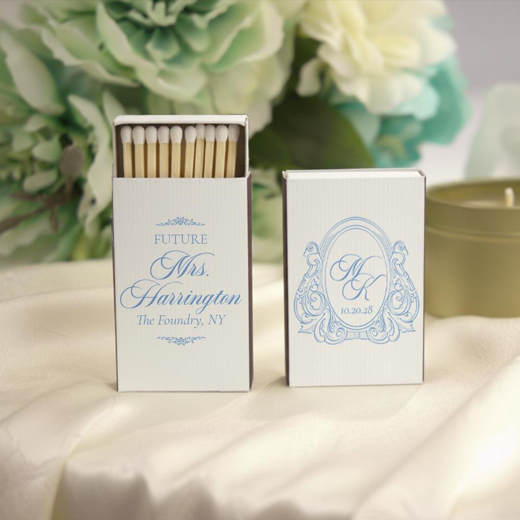 two matchbox sets, one with a decorative design and the other with a monogrammed nameplate.