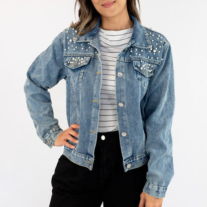 a woman wearing a jean jacket and striped shirt