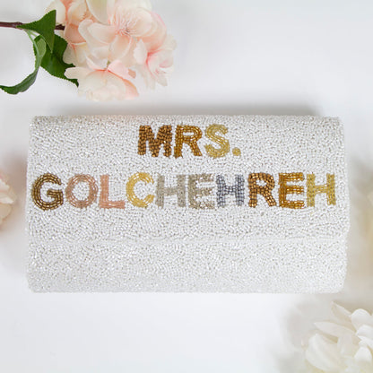 Elegant bridal clutch adorned with intricate beadwork, perfect accessory for a wedding ensemble.