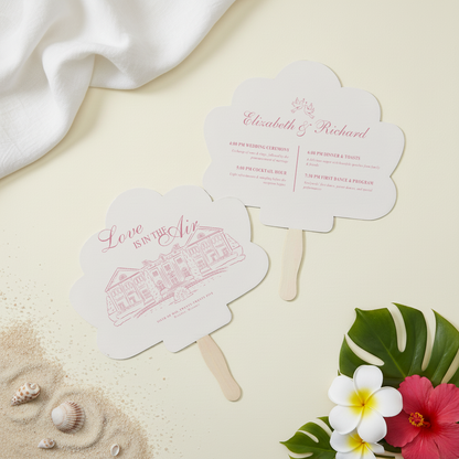two white fan-shaped cards with text and illustrations, placed on a light-colored surface alongside some seashells and flowers.