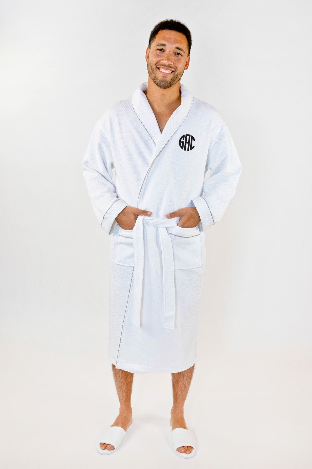 a man wearing a white robe with a monogrammed monogrammed on the