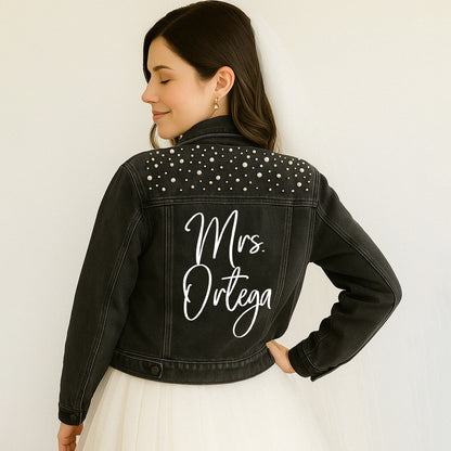 a woman in a white dress and a black jean jacket