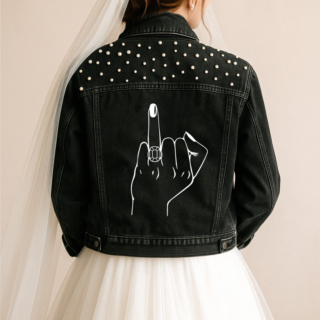 a woman wearing a black jean jacket with a finger on it