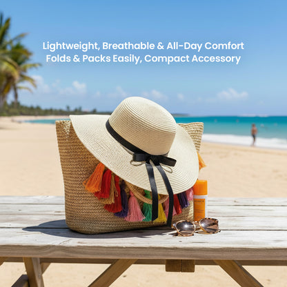 A straw hat with colorful tassels sits on a wooden bench, accompanied by sunglasses and a bottle of sunscreen, with a beach and palm trees in the background.