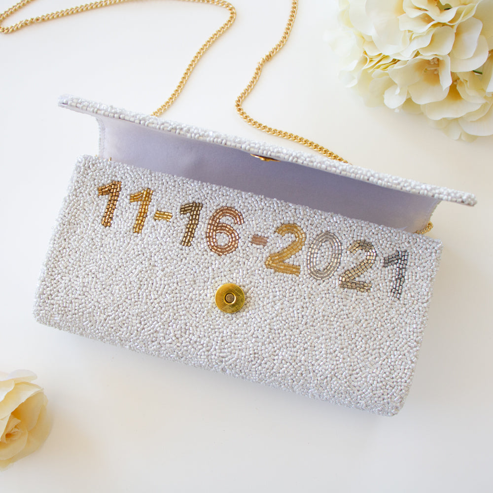 Elegant bridal clutch adorned with intricate beadwork, perfect accessory for a wedding ensemble.