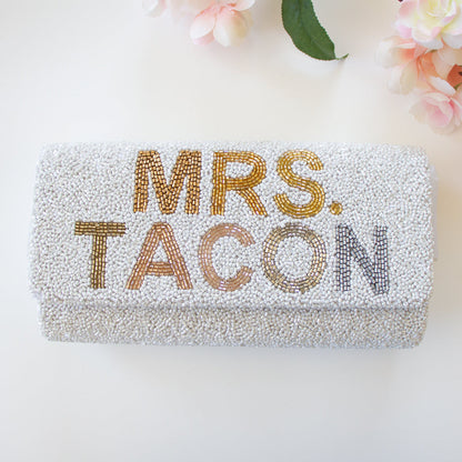 Elegant bridal clutch adorned with intricate beadwork, perfect accessory for a wedding ensemble.