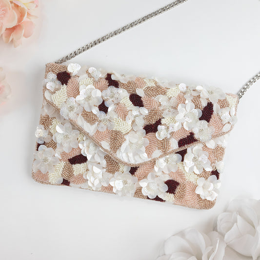 Elegant Pink Floral Beaded Clutch Bag, intricately handcrafted with detailed floral and leaf patterns. Measuring 10in x 7in x 1.5in, this clutch features a durable gold chain and a magnetic snap closure, ideal for brides and bridesmaids to secure essentials. A unique, handmade gift, perfect for bridal showers or appreciation for bridesmaids, ensuring every recipient has a one-of-a-kind accessory for the special day.
