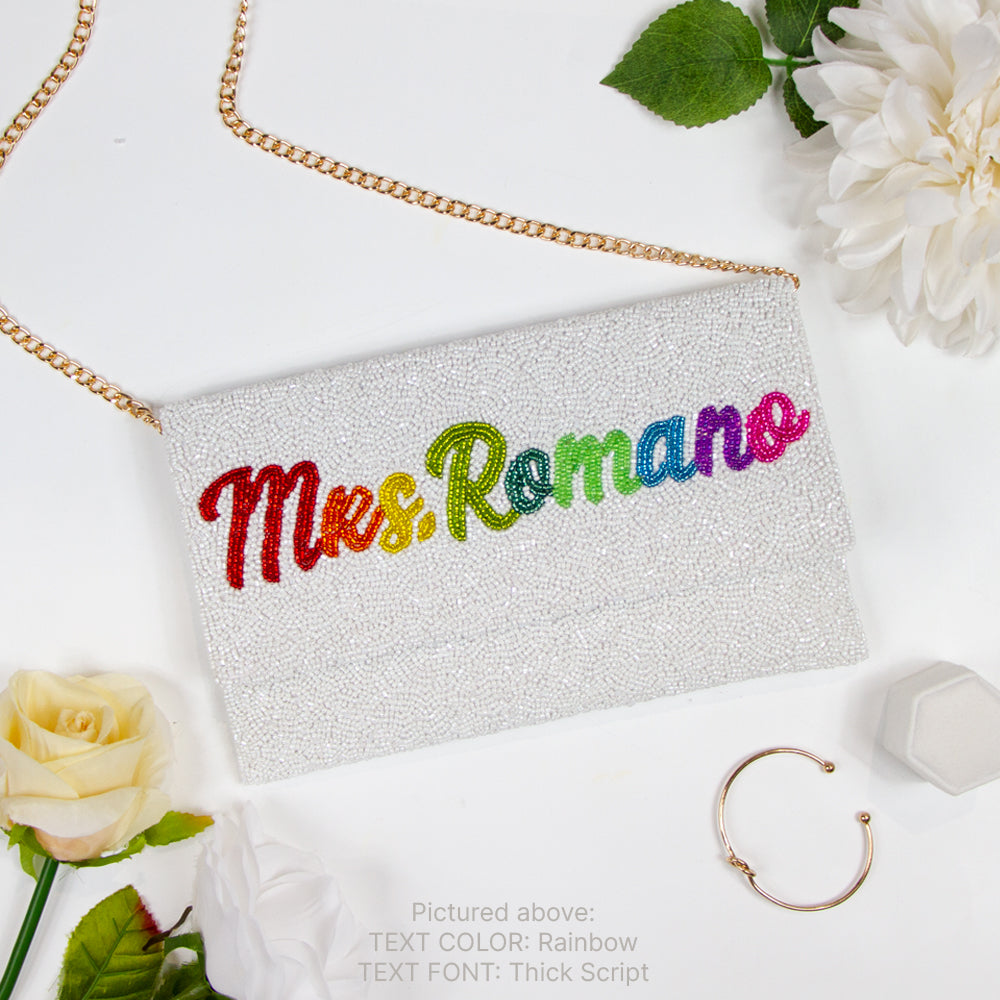 Handcrafted Custom Mrs Last Name Rainbow Bridal Clutch Bag (LHFC) with white text beading, ideal for holding wedding essentials.