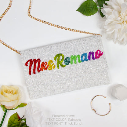 Handcrafted Custom Mrs Last Name Rainbow Bridal Clutch Bag (LHFC) with white text beading, ideal for holding wedding essentials.