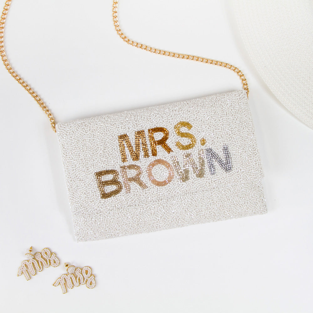 Handmade bridal clutch featuring bubble letters seed bead design, perfect for wedding day essentials. Elegant and unique addition for brides.