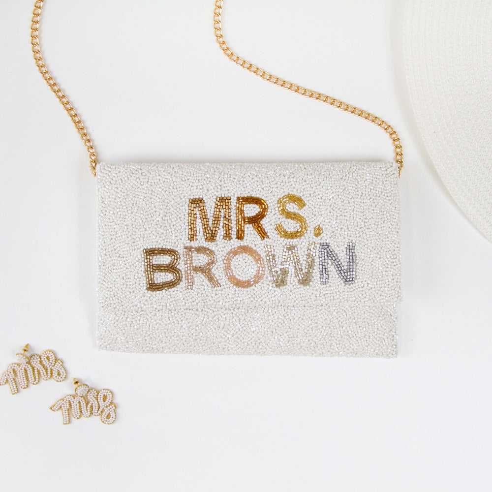 Chic Bridal Clutch: Personalized Seed Bead Clutch Purse for Brides, measuring 9 1/2″ wide x 5″ tall. Handcrafted with a velvet interior, this clutch offers both style and functionality for brides. Every handmade clutch is uniquely designed, making it an exquisite accessory for the special day.