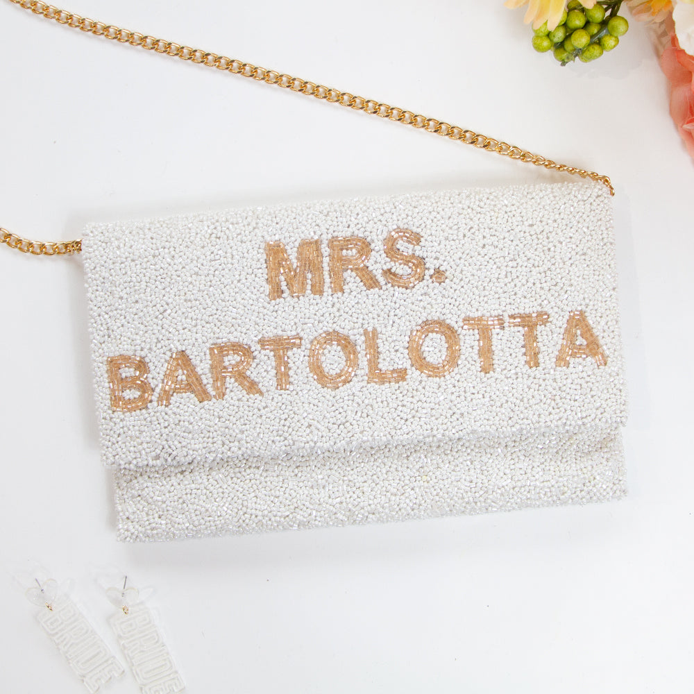 Chic Bridal Clutch: Personalized Seed Bead Clutch Purse for Brides, measuring 9 1/2″ wide x 5″ tall. Handcrafted with a velvet interior, this clutch offers both style and functionality for brides. Every handmade clutch is uniquely designed, making it an exquisite accessory for the special day.