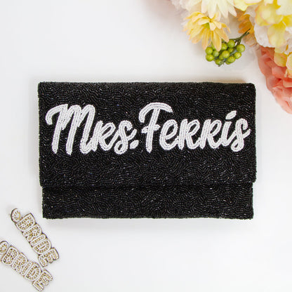 Chic Bridal Clutch: Personalized Seed Bead Clutch Purse for Brides, measuring 9 1/2″ wide x 5″ tall. Handcrafted with a velvet interior, this clutch offers both style and functionality for brides. Every handmade clutch is uniquely designed, making it an exquisite accessory for the special day.