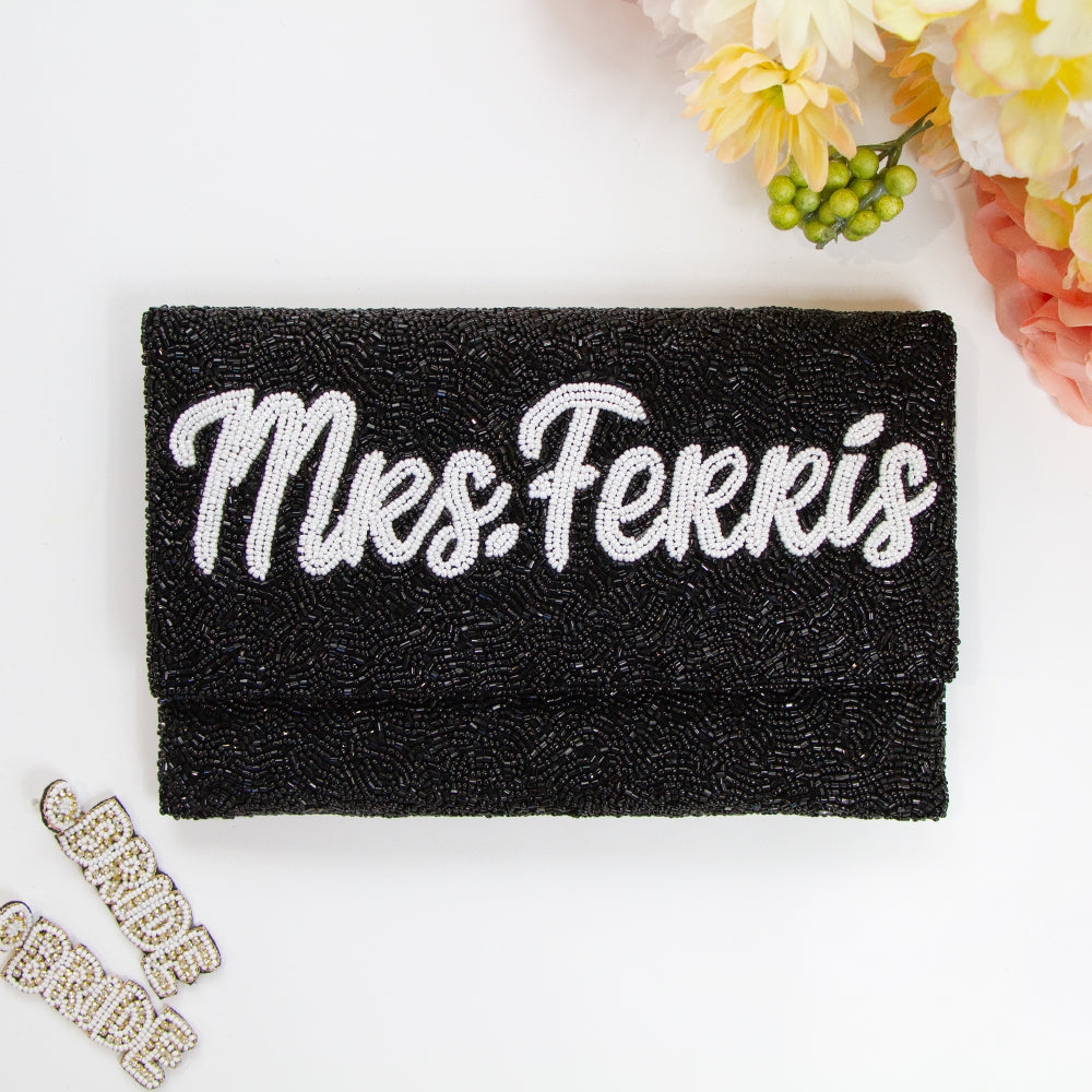 Chic Bridal Clutch: Personalized Seed Bead Clutch Purse for Brides, measuring 9 1/2″ wide x 5″ tall. Handcrafted with a velvet interior, this clutch offers both style and functionality for brides. Every handmade clutch is uniquely designed, making it an exquisite accessory for the special day.