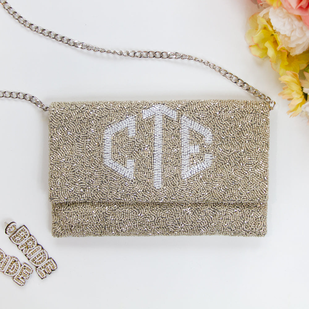 Handmade bridal clutch featuring bubble letters seed bead design, perfect for wedding day essentials. Elegant and unique addition for brides.