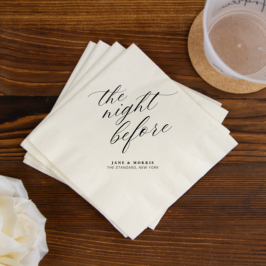 Stack of white napkins with 'the night before' text on a wooden table.