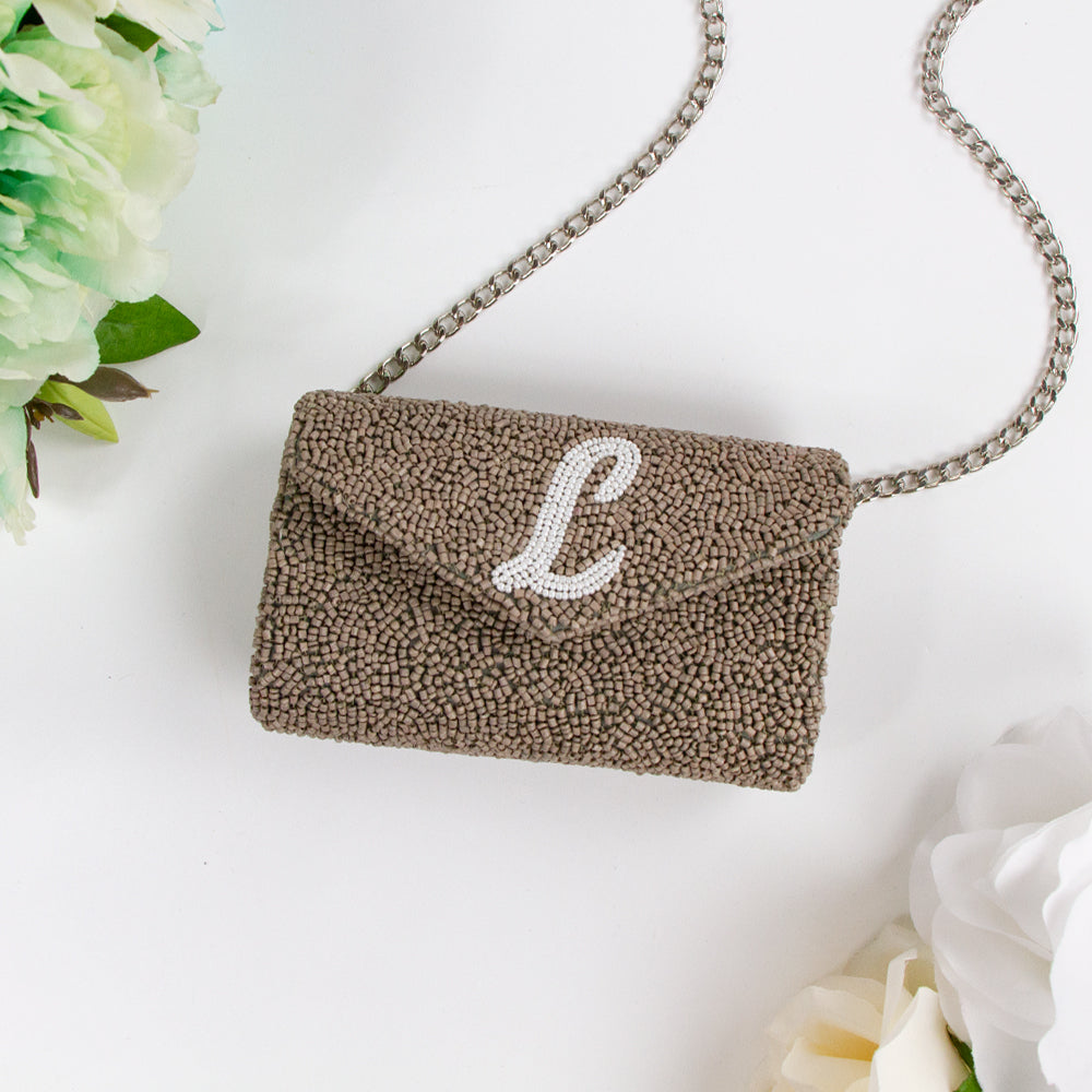 Exquisite Custom Tiny Envelope Bridal Clutch with detailed beading, ideal for weddings and special occasions. Perfect for personalization with up to two letters. Dimensions of 5.5in x 3.5in x 2in, suitable for carrying essentials like keys and lip gloss. Each handcrafted piece is unique, showcasing artisanal brilliance
