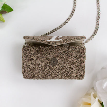 Exquisite Custom Tiny Envelope Bridal Clutch with detailed beading, ideal for weddings and special occasions. Perfect for personalization with up to two letters. Dimensions of 5.5in x 3.5in x 2in, suitable for carrying essentials like keys and lip gloss. Each handcrafted piece is unique, showcasing artisanal brilliance