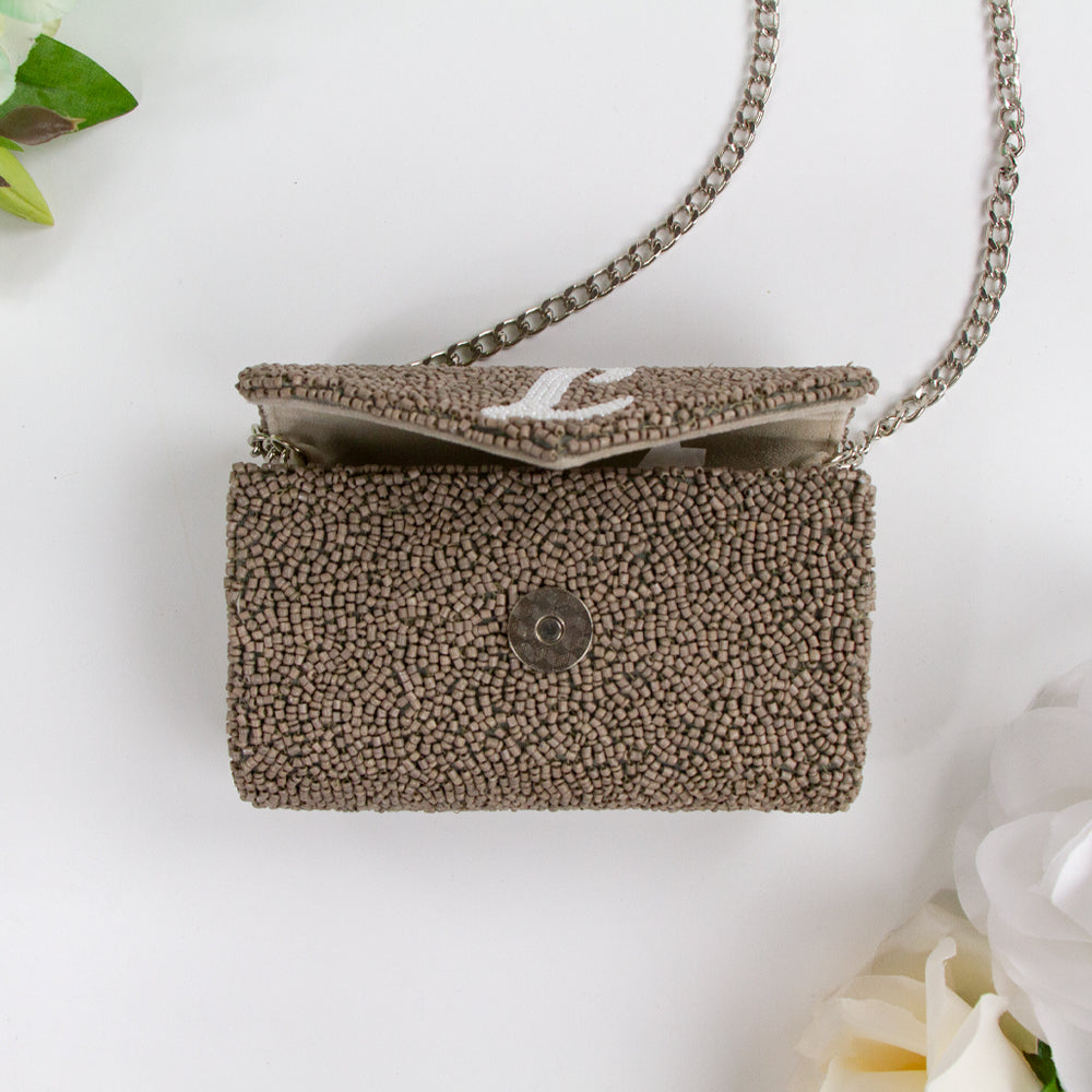 Exquisite Custom Tiny Envelope Bridal Clutch with detailed beading, ideal for weddings and special occasions. Perfect for personalization with up to two letters. Dimensions of 5.5in x 3.5in x 2in, suitable for carrying essentials like keys and lip gloss. Each handcrafted piece is unique, showcasing artisanal brilliance
