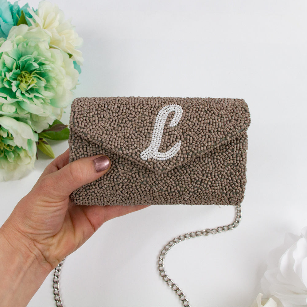 Exquisite Custom Tiny Envelope Bridal Clutch with detailed beading, ideal for weddings and special occasions. Perfect for personalization with up to two letters. Dimensions of 5.5in x 3.5in x 2in, suitable for carrying essentials like keys and lip gloss. Each handcrafted piece is unique, showcasing artisanal brilliance