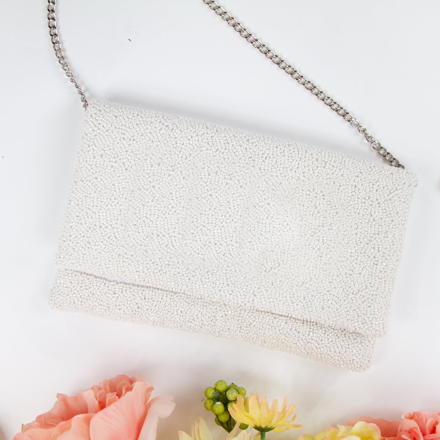 Title/bridal Clutch "Elegant white beaded bridal clutch, handmade to perfection, sized at 10.5 x 7 x 1 inches. This durable canvas bridal clutch with magnetic snap closure offers a stylish and practical solution for the wedding day, ensuring each bride has a unique accessory for her special occasion."