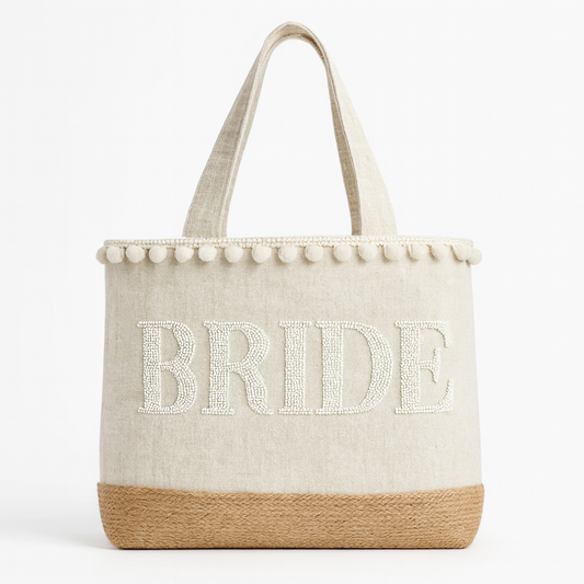 A beige tote bag with the word "BRIDE" embroidered on it in white letters.