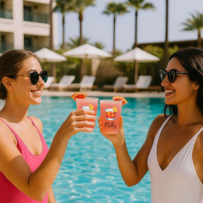 a couple of women standing next to a swimming pool