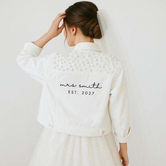 a woman in a white dress and a white jacket