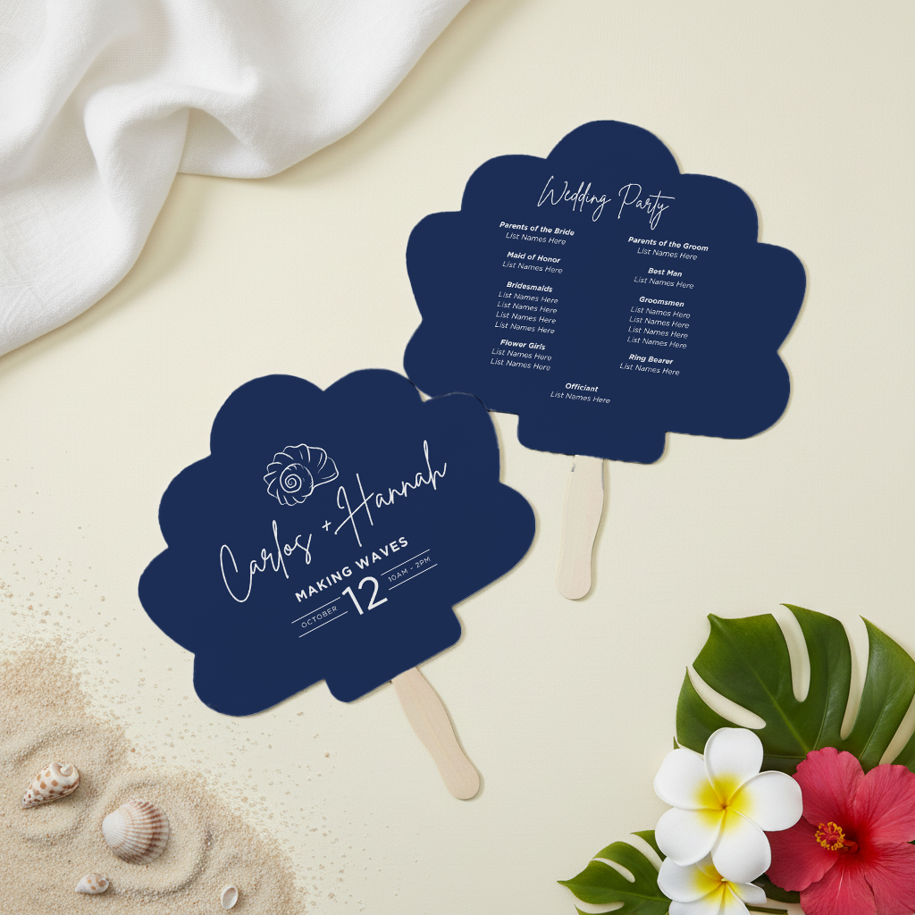 a blue fan-shaped card with the text "Carlos + Hannah Making Waves 12" and a list of names, along with a wedding party schedule. The fan is placed on a table with seashells and flowers, and there is a white cloth in the background.