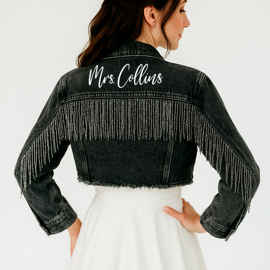 a woman wearing a jean jacket with a name on it