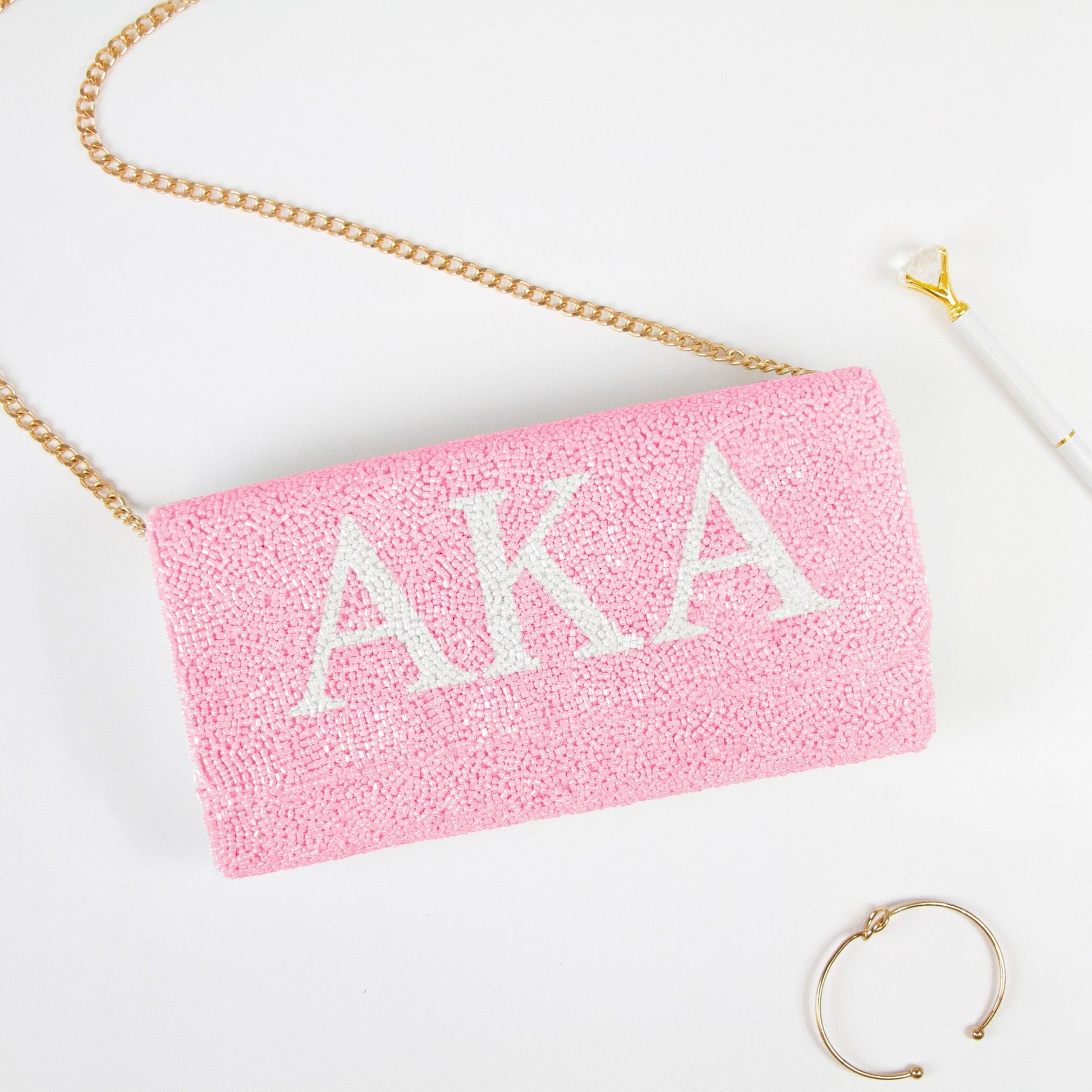 Elegant Personality Sorority Beaded Clutch Bag, handcrafted with intricate detailing, perfect for weddings and special occasions. Features options for gold or silver chain and dimensions of 9.5in x 5in x 3in. Unique customization includes a date on the inside. Each clutch embodies artisanal uniqueness and craftsmanship