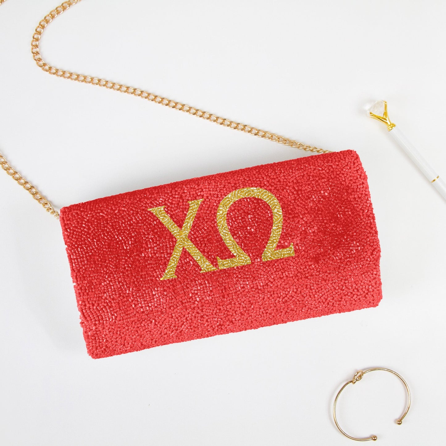 Elegant Personality Sorority Beaded Clutch Bag, handcrafted with intricate detailing, perfect for weddings and special occasions. Features options for gold or silver chain and dimensions of 9.5in x 5in x 3in. Unique customization includes a date on the inside. Each clutch embodies artisanal uniqueness and craftsmanship