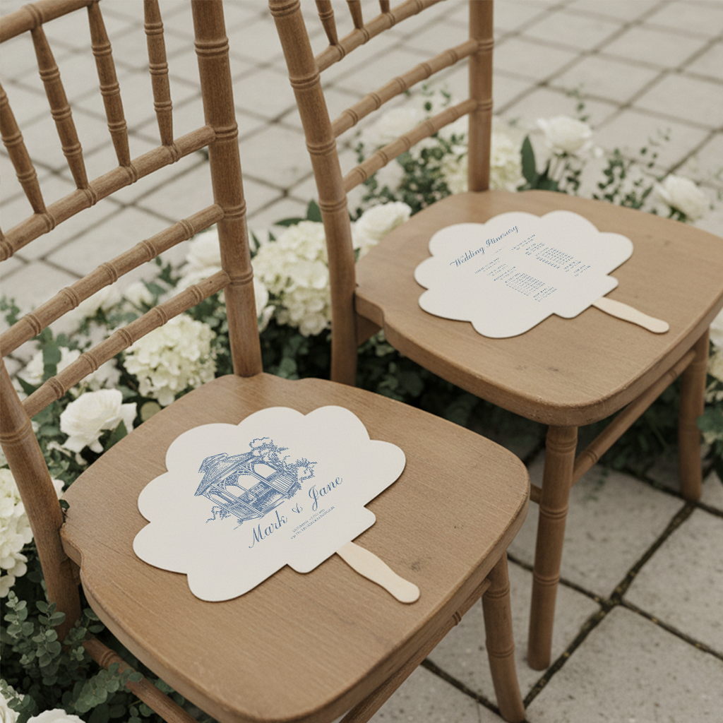 two wooden chairs with white fan-shaped menus on them, placed on a tiled floor surrounded by white flowers.