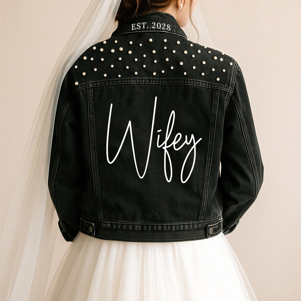 a woman wearing a black jacket with a name on it