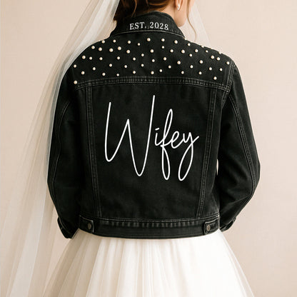 a woman wearing a black jacket with a name on it