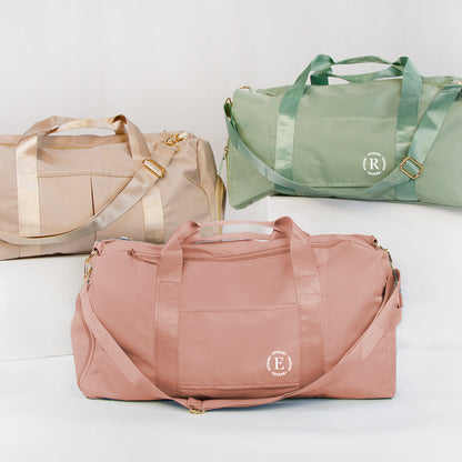 three colorful duffel bags, each with a unique color and design, arranged side by side.