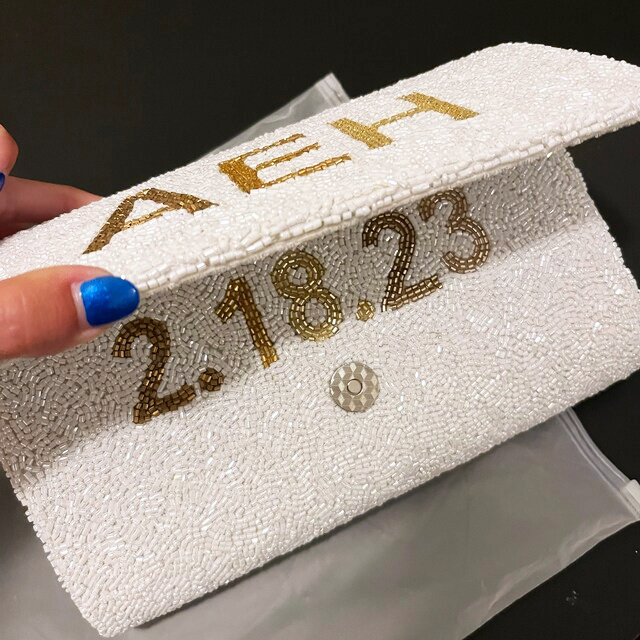 Handmade Custom Design Clutch (LHFC) with rainbow beading and white text, perfect for weddings and special events. Features gold or silver chain and unique beaded patterns, ideal for brides seeking a one-of-a-kind bridal clutch
