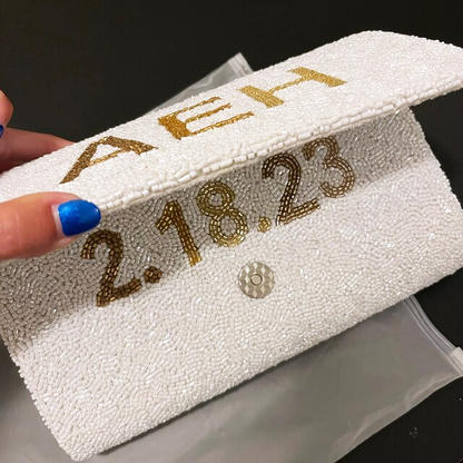 Handmade Custom Design Clutch (LHFC) with rainbow beading and white text, perfect for weddings and special events. Features gold or silver chain and unique beaded patterns, ideal for brides seeking a one-of-a-kind bridal clutch