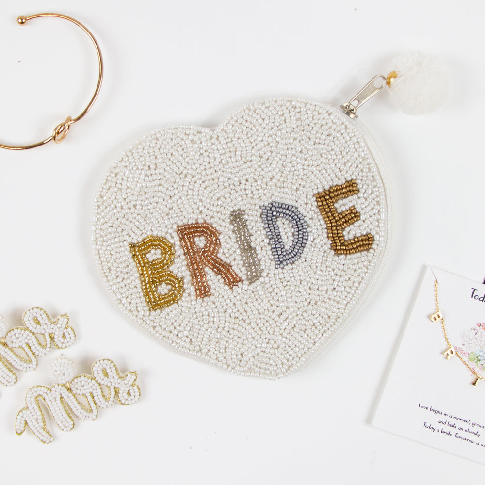 Elegant Bride Coin Purse featuring intricate hand-beaded design. This bridal clutch, made of durable canvas, presents a beautiful contrast of matte white beading and gold shine. Perfect for weddings, it offers a secure zipper to keep belongings safe. Measuring compactly, it's both stylish and functional, allowing brides to carry their essentials with grace. Each purse is uniquely crafted, ensuring a one-of-a-kind accessory for any special occasion