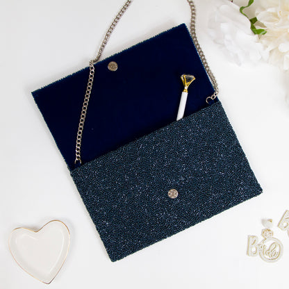 Exquisite Bridal Clutch: Custom Monogram Clutch Purse measuring 9 1/2″ wide x 5″ tall. Featuring rainbow clutch design with white text beading, complemented by a velvet interior. Each handmade clutch is unique, ideal for brides desiring a personalized touch on their special day