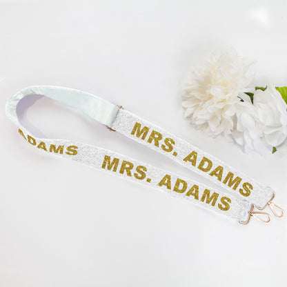 Custom 'Mrs.' Beaded Camera Strap in various trendy shades, ideal for personalizing bags and showcasing married status. Measures 46 inches with secure attachment clips. Each handcrafted strap offers unique design variations and individuality